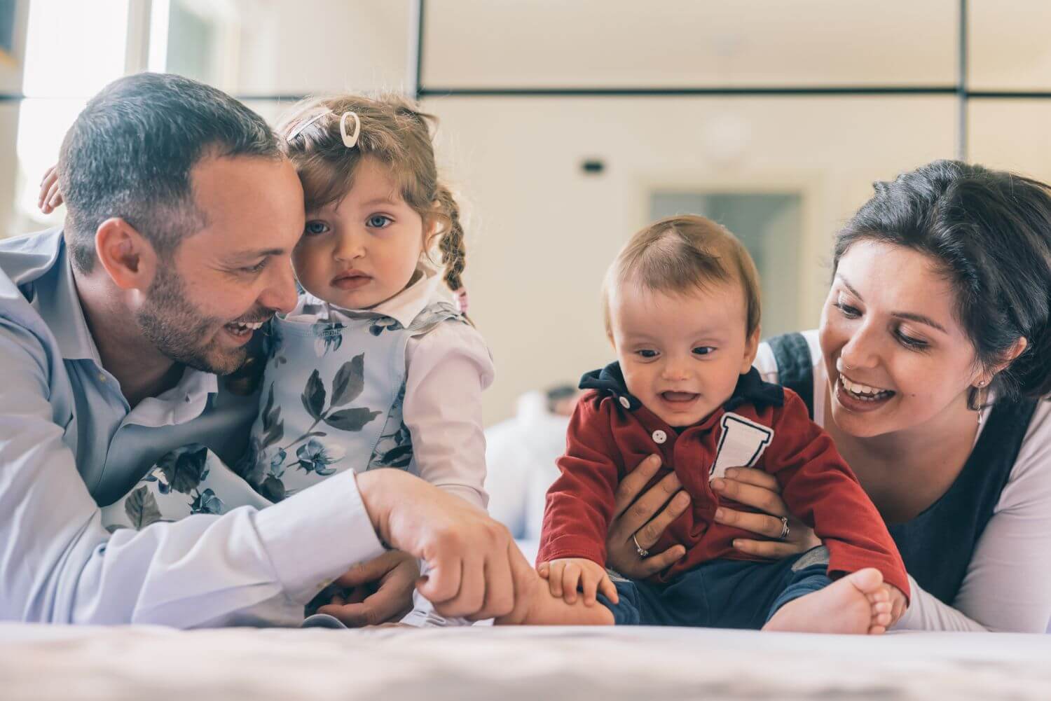 happy-family-with-two-kids-indoor-at-home-playing-2022-01-21-23-19-46-utc (1)