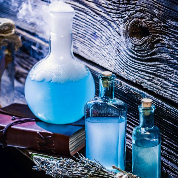 closeup-of-magical-blue-potions-in-witch-cottage-f-2022-04-11-21-10-34-utc