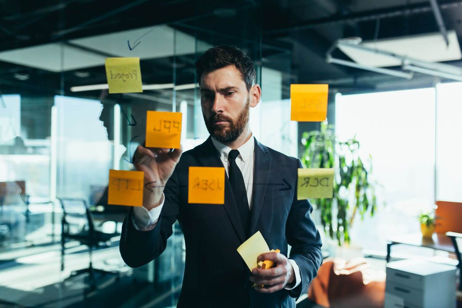businessman-in-reflection-at-a-glass-task-board-h-2022-12-08-04-13-27-utc